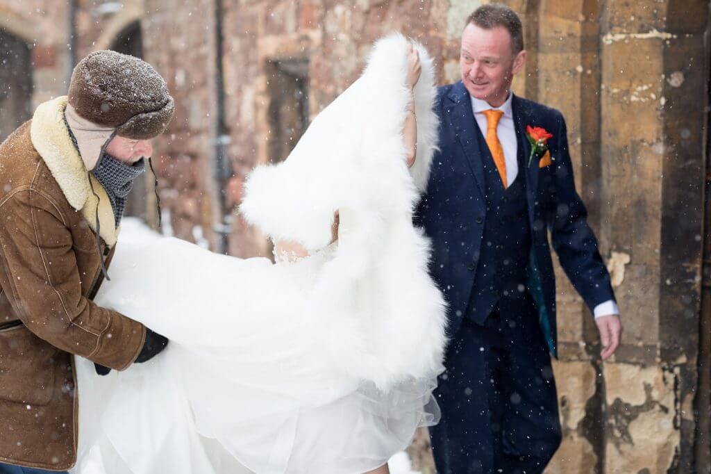 04 father of the bride with daughter in snow flurry berkeley castle stately home gloucestershire oxfordshire wedding photographer