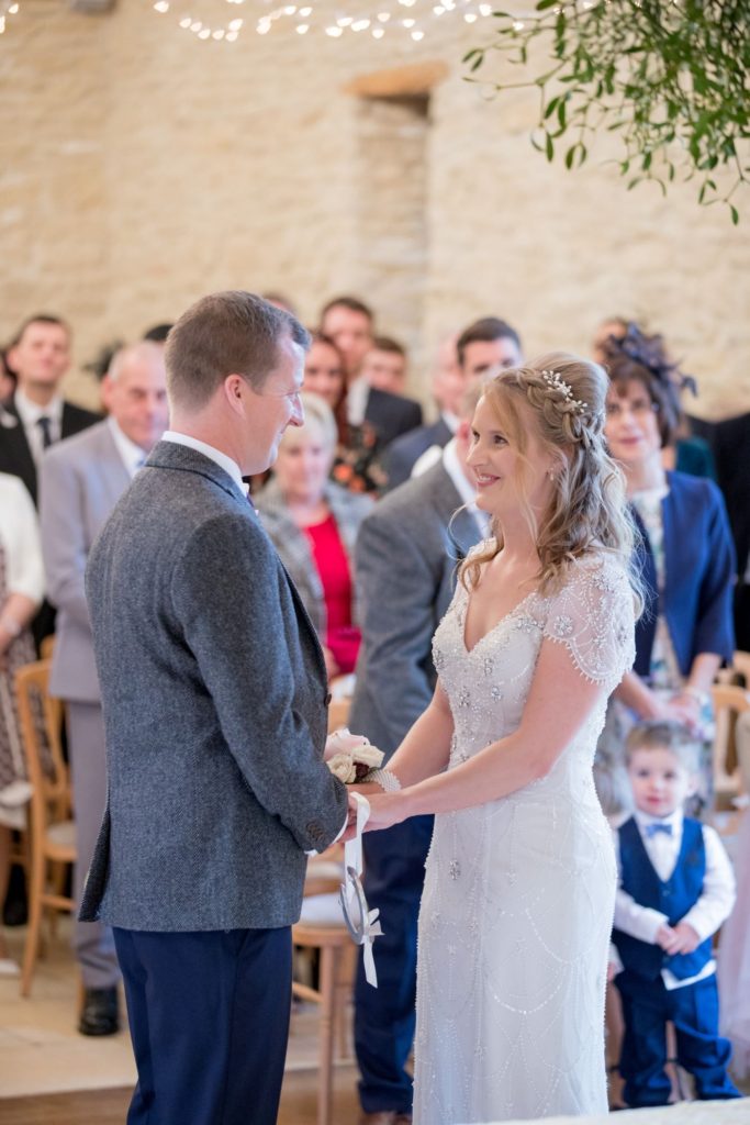 70 bride and groom under misletoe kingscote barn marriage ceremony oxford wedding photographer