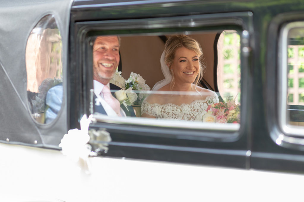 30 smiling father of bride daughter open bridal car the elvetham hartley wintney hampshire oxfordshire wedding photography