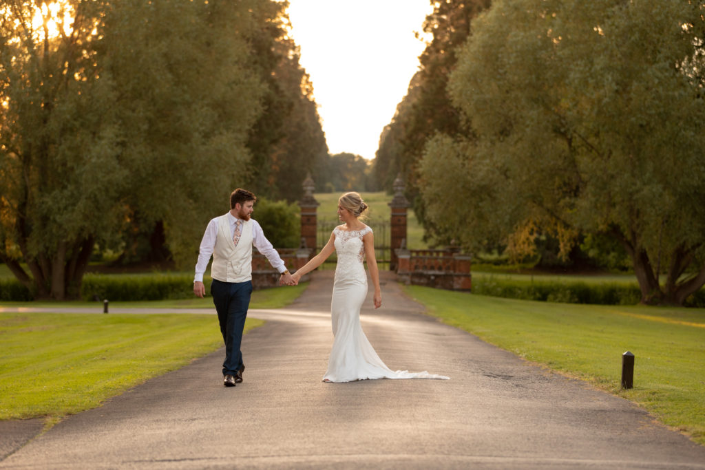 112 bride groom hold hands setting sun the elvetham gardens hartley wintney hampshire oxfordshire wedding photographer