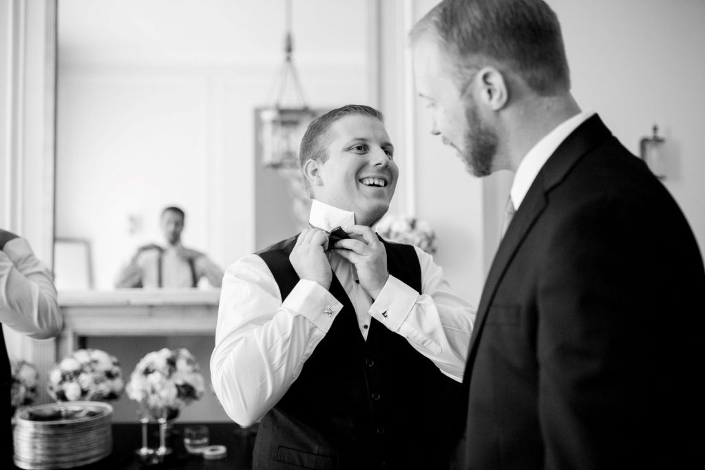 08 groom adjusts bow tie academy of medical sciences portland place london oxford wedding photographers