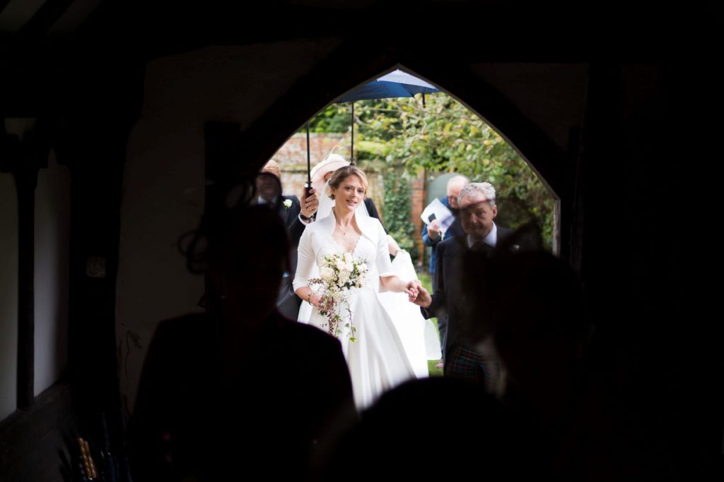 bride with father enter church of st michael aston tirrold oxfordshire oxford wedding photographer
