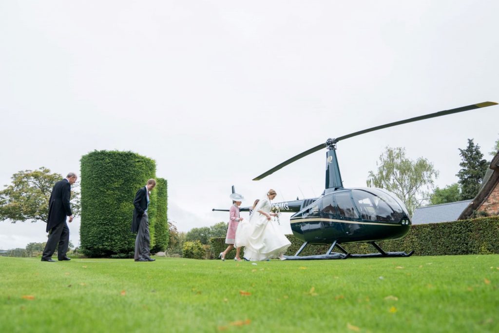 bride groom board helicopter for blenheim palace venue woodstock oxfordshire oxford wedding photographer