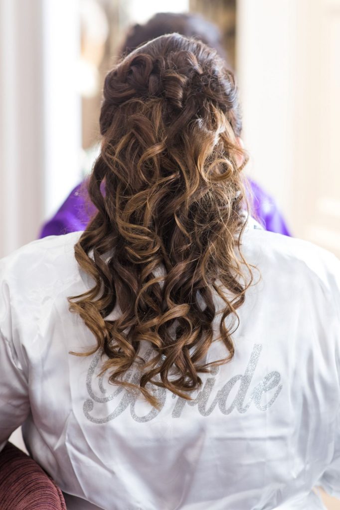 bride completes hair styling bridal prep sir christoper wren hotel windsor oxford wedding photographer