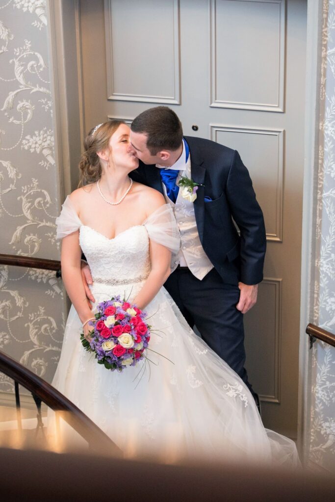 bride grooms staircase kiss de vere beaumont estate windsor oxford wedding photography